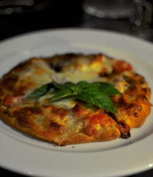 Thin crisp pizza - proscuitto, puree garlic, roma tomato, olives, caremelised onion, mozarella $18